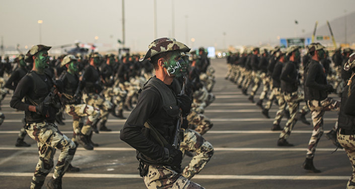 In this Thursday, Sept. 17, 2015 file photo, Saudi security forces, whose faces display the word Decisive take part in a military parade.